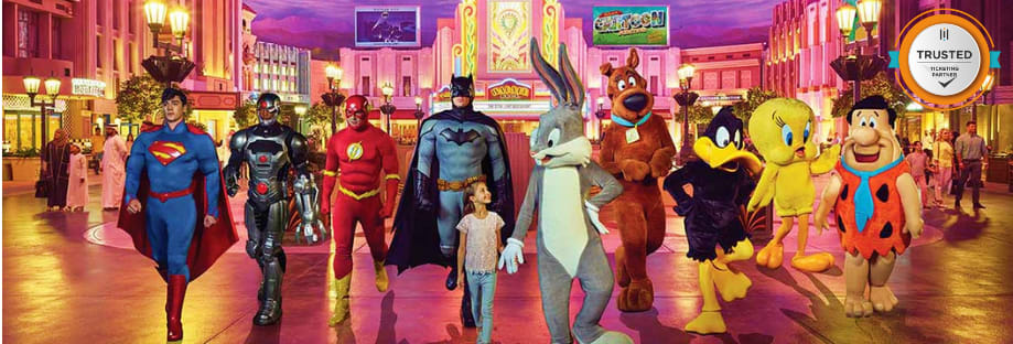 Characters and superheroes walking through a vibrant, neon-lit theme park street with colorful buildings and arcade games